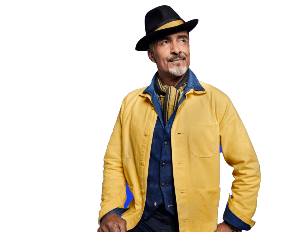 Potential KRAZATI® patient dressed in a yellow and blue jacket and a top hat against a blue background.