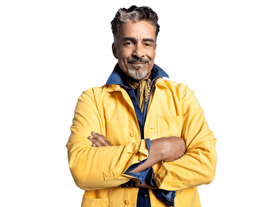 Potential KRAZATI® patient, standing arms crossed, dressed in a yellow and blue jacket against a blue background.