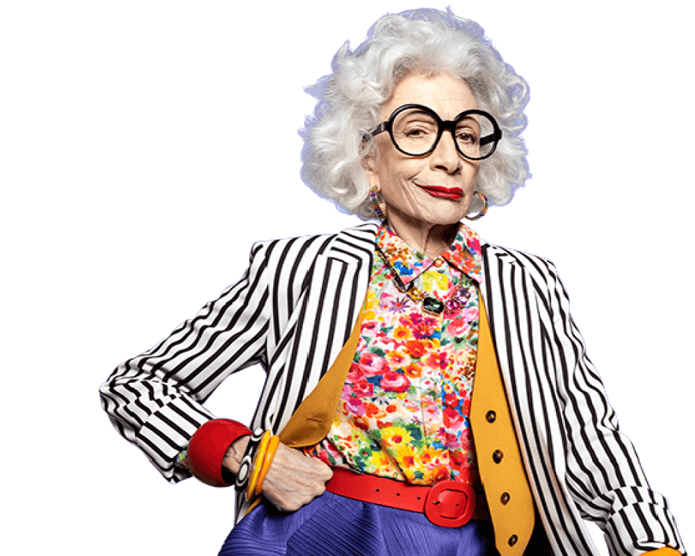 Potential KRAZATI® patient wearing a colorful top and black and white striped jacket against a blue background.